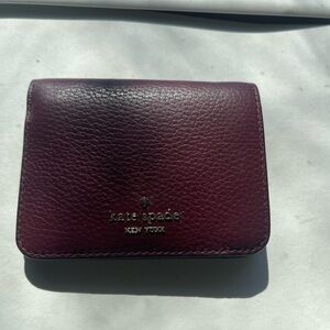 kate spade Pebbled Leather Compact Wallet in Plum